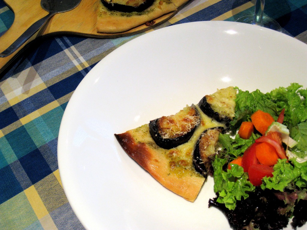 Eggplant and pesto pizza with salad