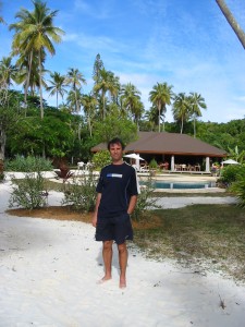 Adriano in front of a small resort on the Isle of Pines