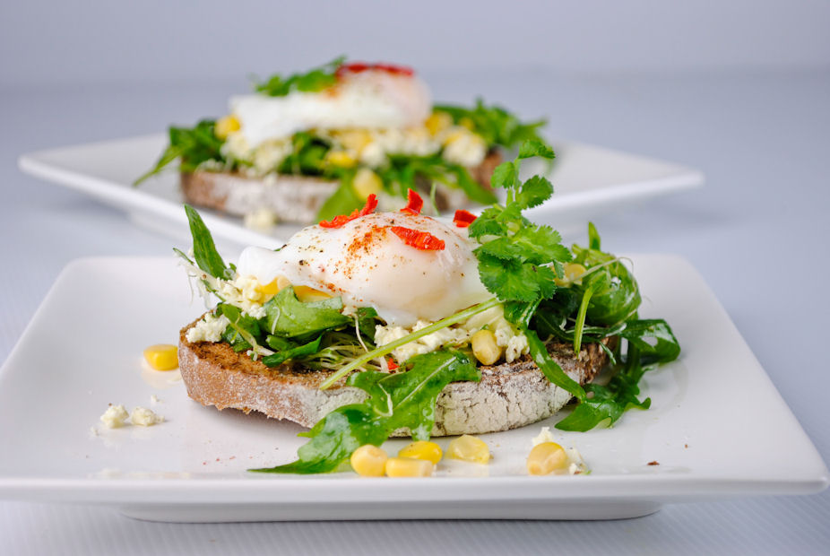 Goat cheese, arugula and poached egg open sandwich 