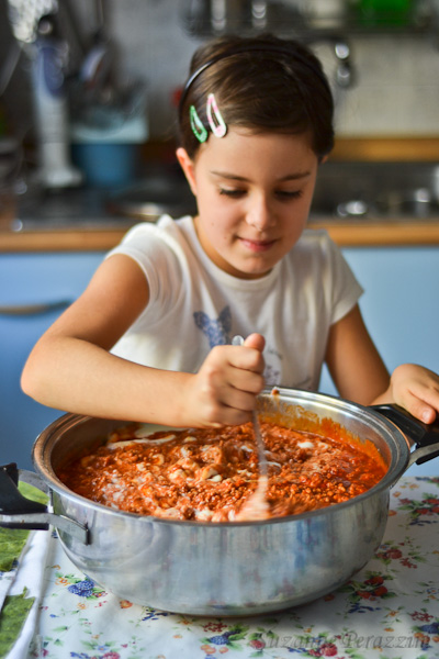 Sofia mixing the ragu sauce into the white sauce